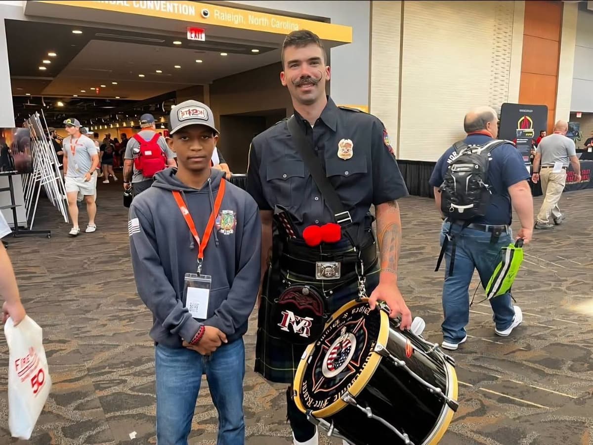 A Gaston Fire and Rescue cadet meeting a firefighter at the South Atlantic Fire Rescue Expo