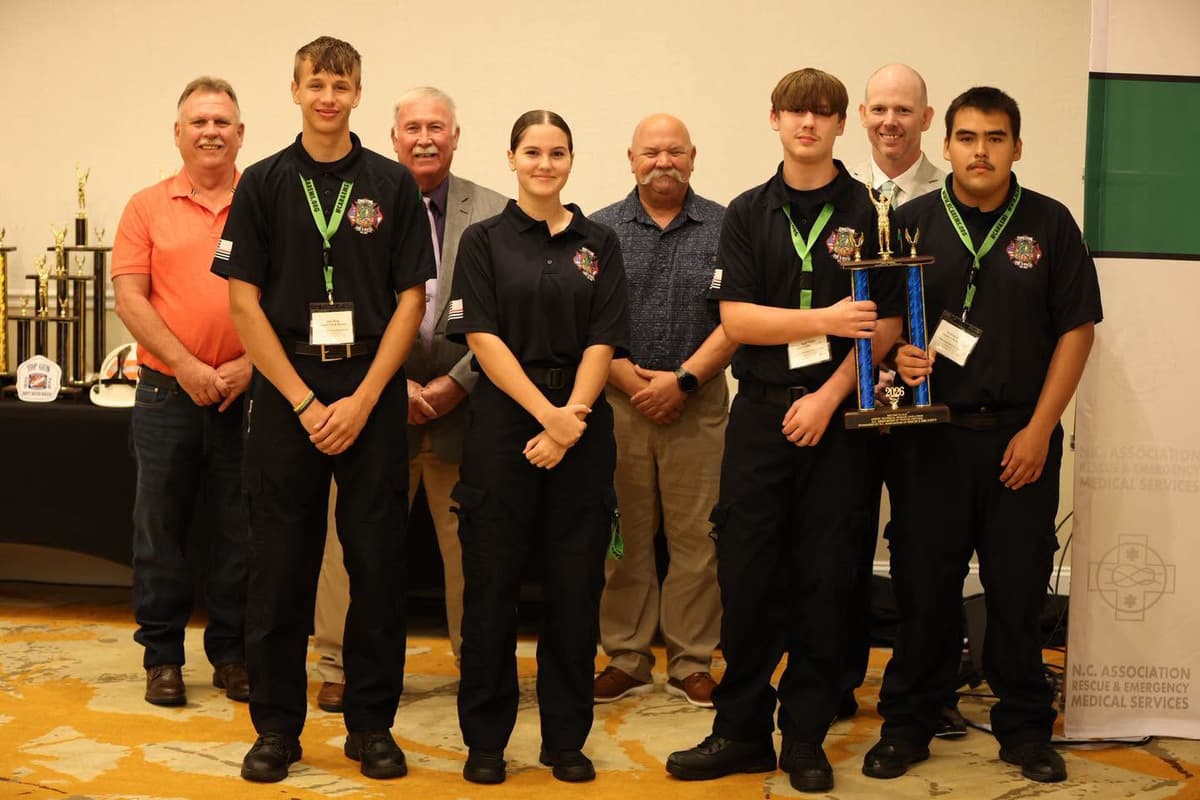 Four Gaston cadets gathered with a trophy and medals at the association's awards presentation