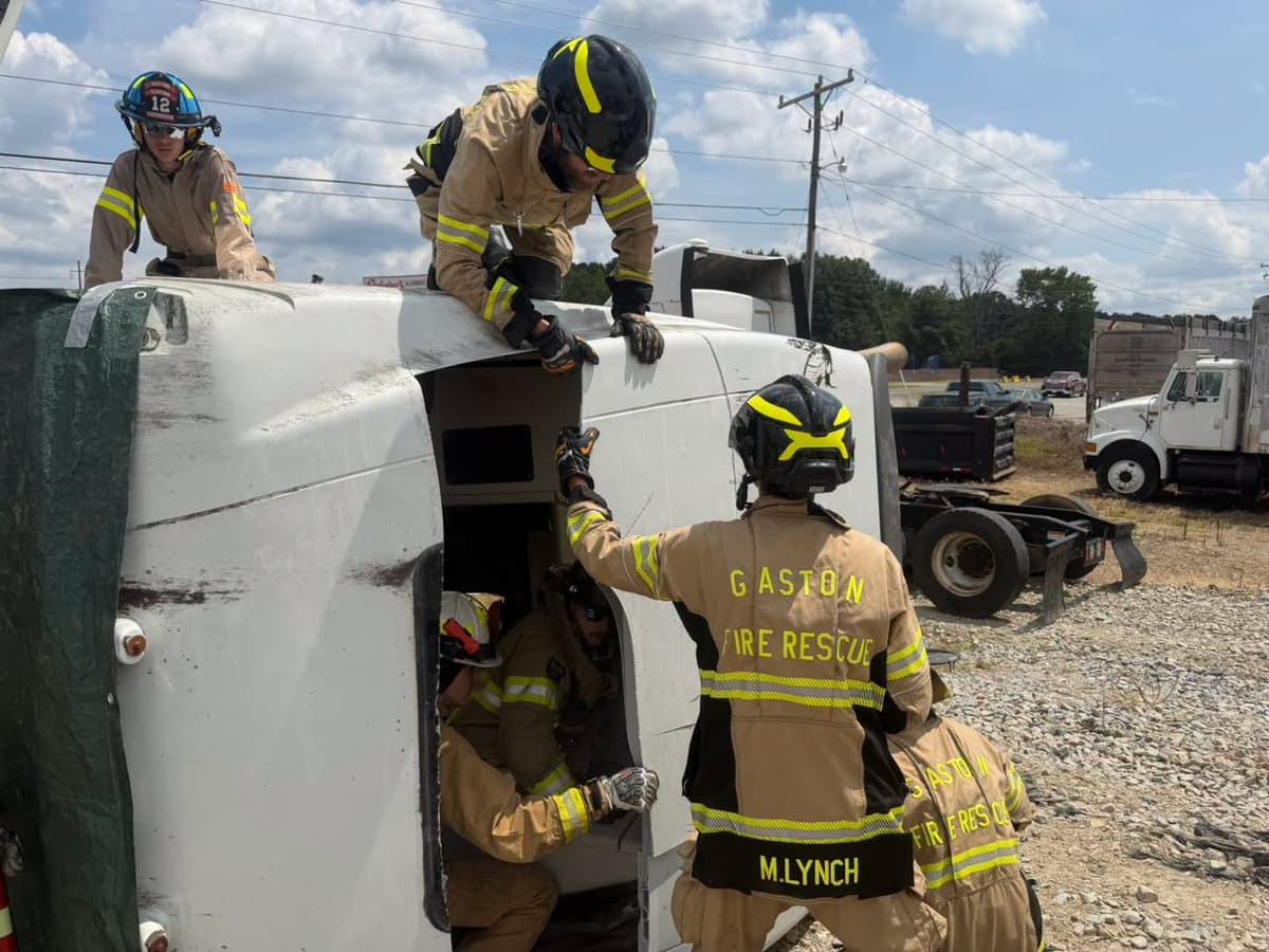 Gaston Fire and Rescue members accessing the cab of a tractor on its side