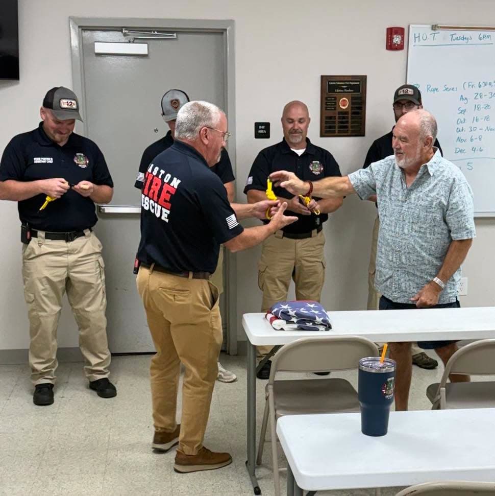 A Gaston member accepting his knot while other members examine theirs