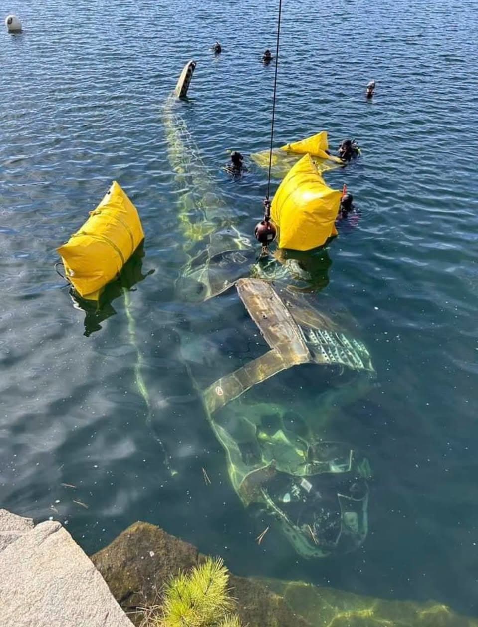 Public safety divers working around a submerged vehicle during training