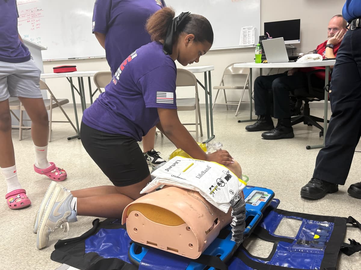 A camper practices CPR with Halifax County EMS