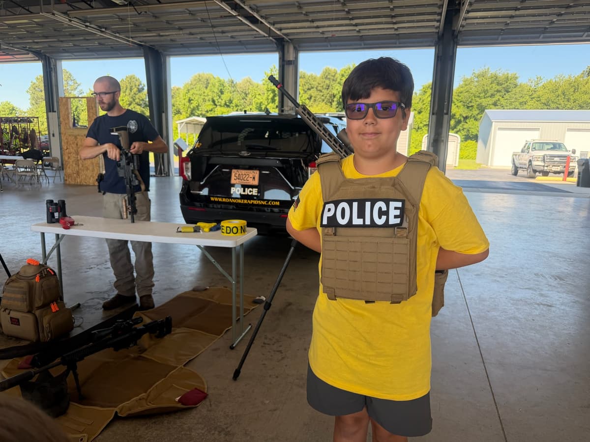 A camper tries on a police vest